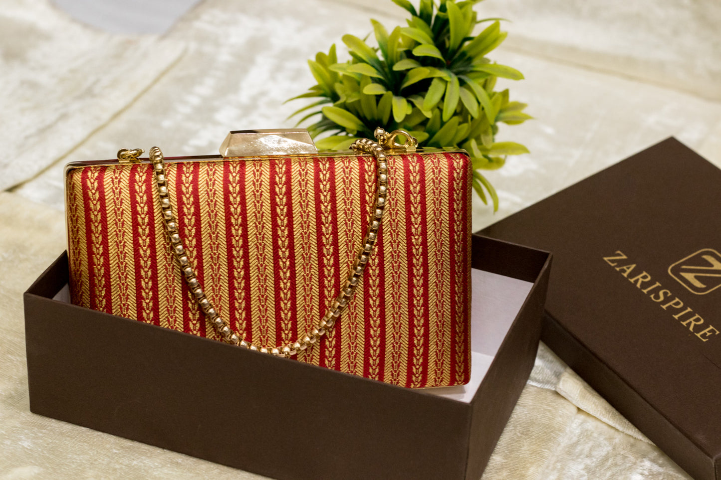 Red banarasi brocade clutch bag with gold chain, traditional handmade clutches in decorative box.