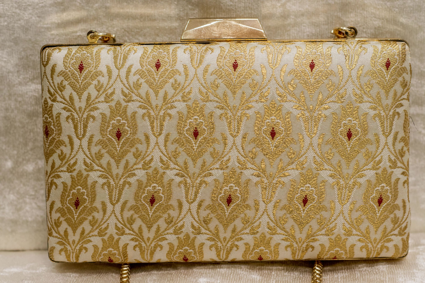 Ivory Banarasi brocade clutch bag with traditional gold floral patterns, handmade finish.
