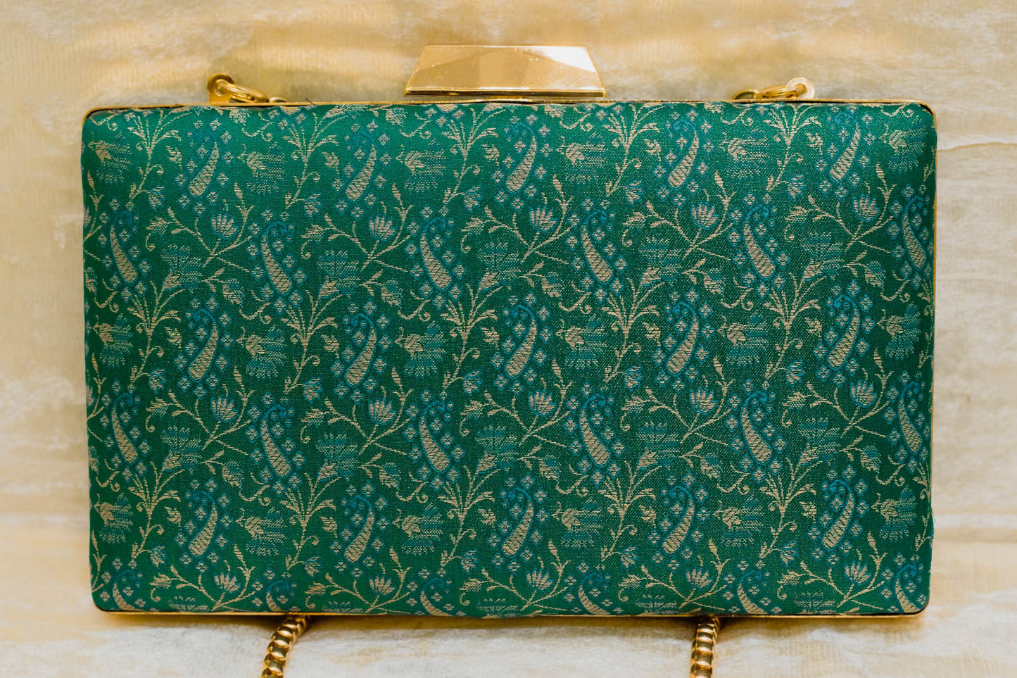 Teal brocade Banarasi clutch bag with traditional floral pattern, handmade sleek design.