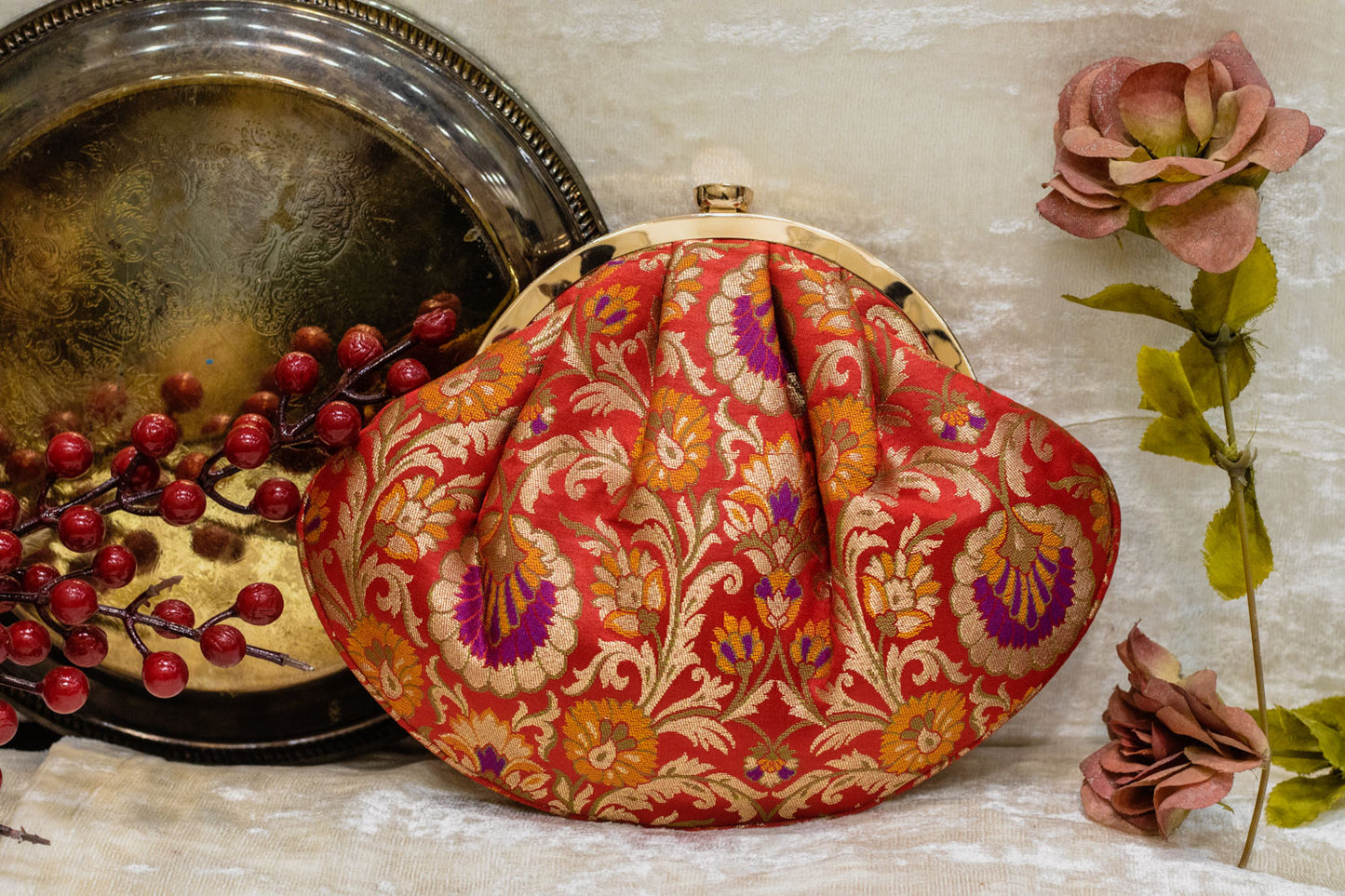 Red traditional Banarasi brocade clutch bag with intricate gold floral brocade, handmade design.