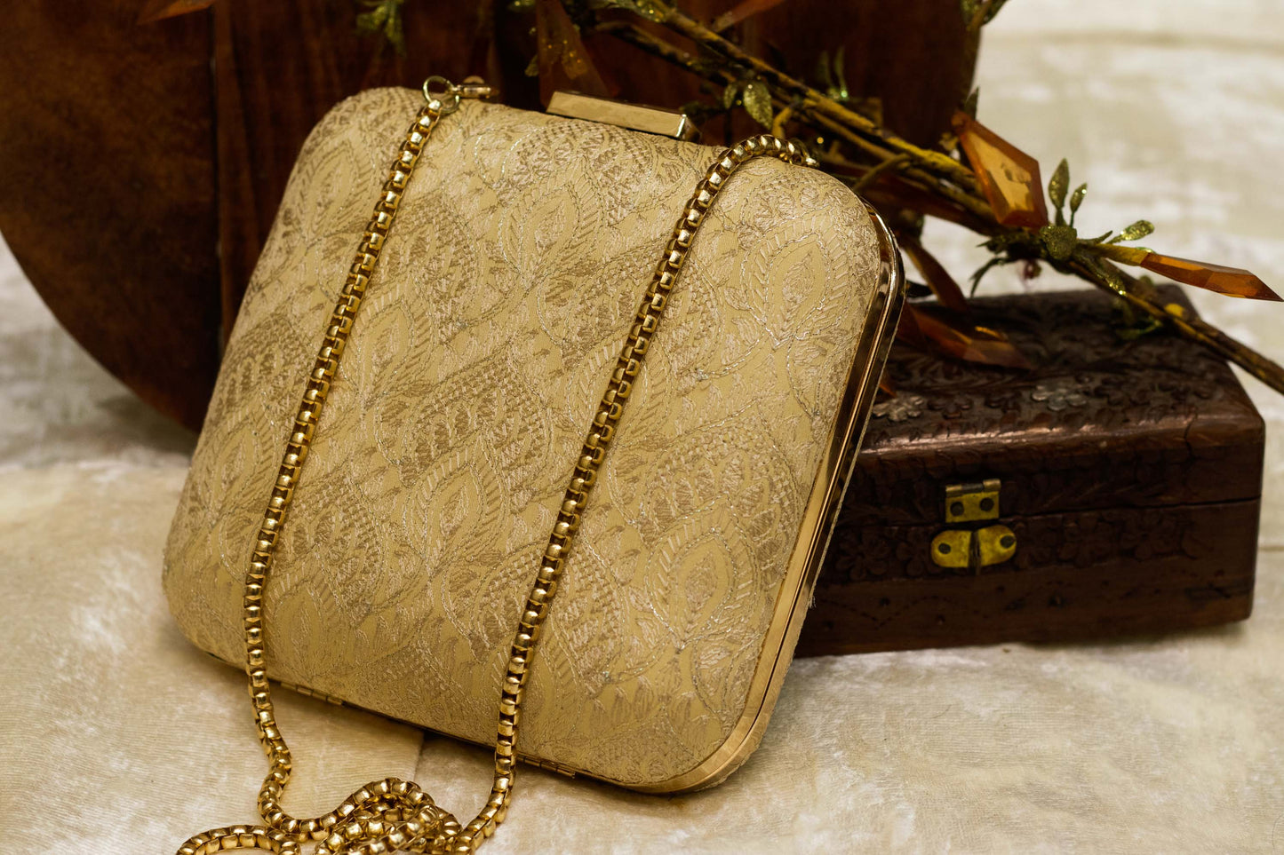 Beige traditional handmade brocade Banarasi clutch bag with gold chain strap.