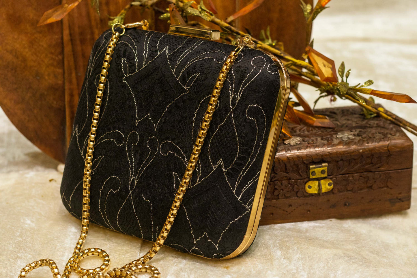 Black handmade brocade Banarasi clutch bag with traditional chikankari embroidery and gold chain strap.