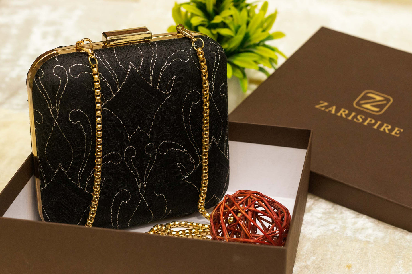 Black Banarasi brocade clutch bag with traditional Chikankari embroidery and gold chain strap, handmade.