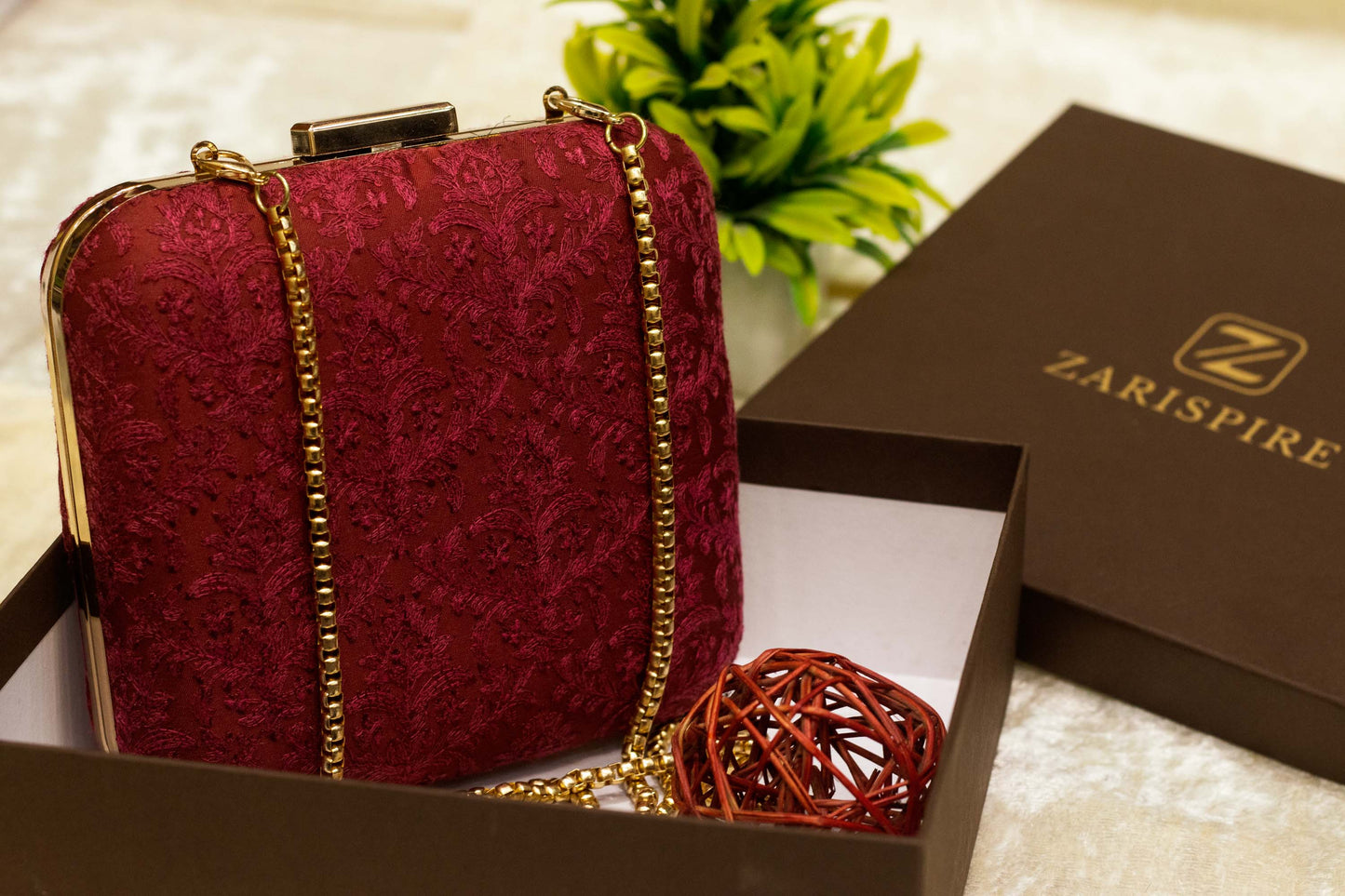 Maroon Banarasi brocade clutch bag with intricate traditional chikankari embroidery, handmade with gold chain strap.