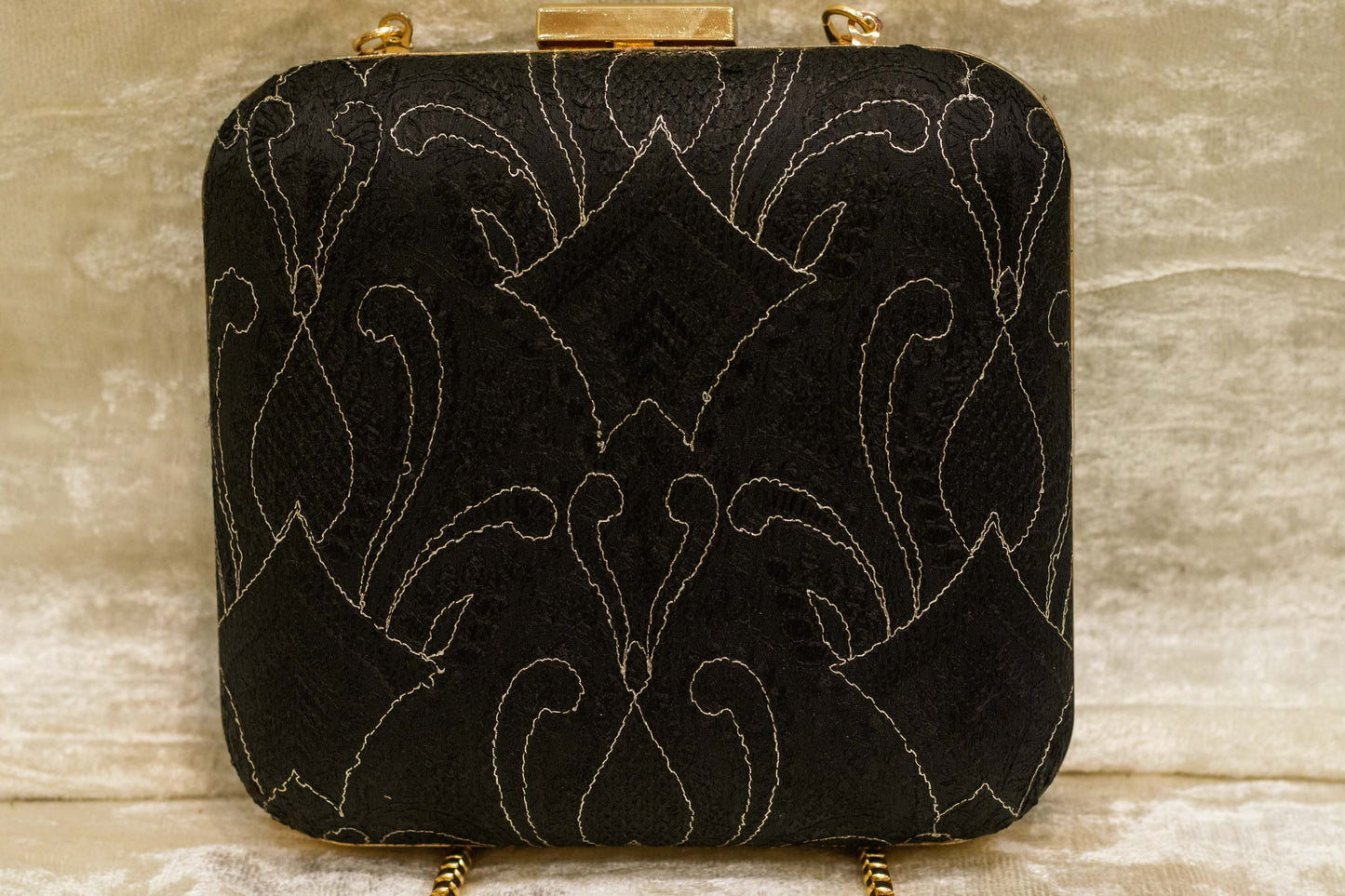 Black brocade clutch bag with intricate traditional Banarasi chikankari embroidery, handmade design.