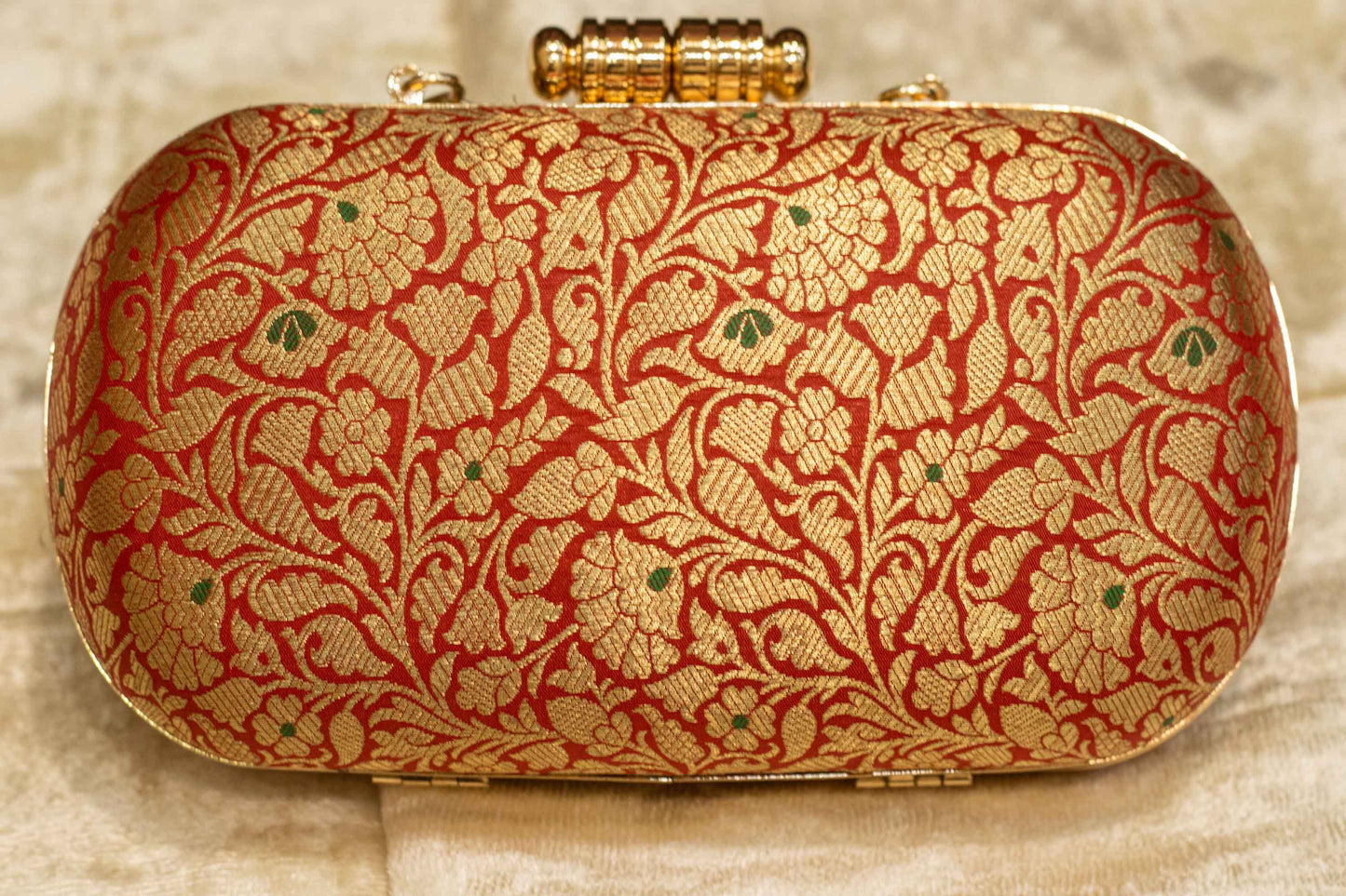 Red Banarasi brocade clutch bag with gold floral pattern, traditional handmade capsule clutch.