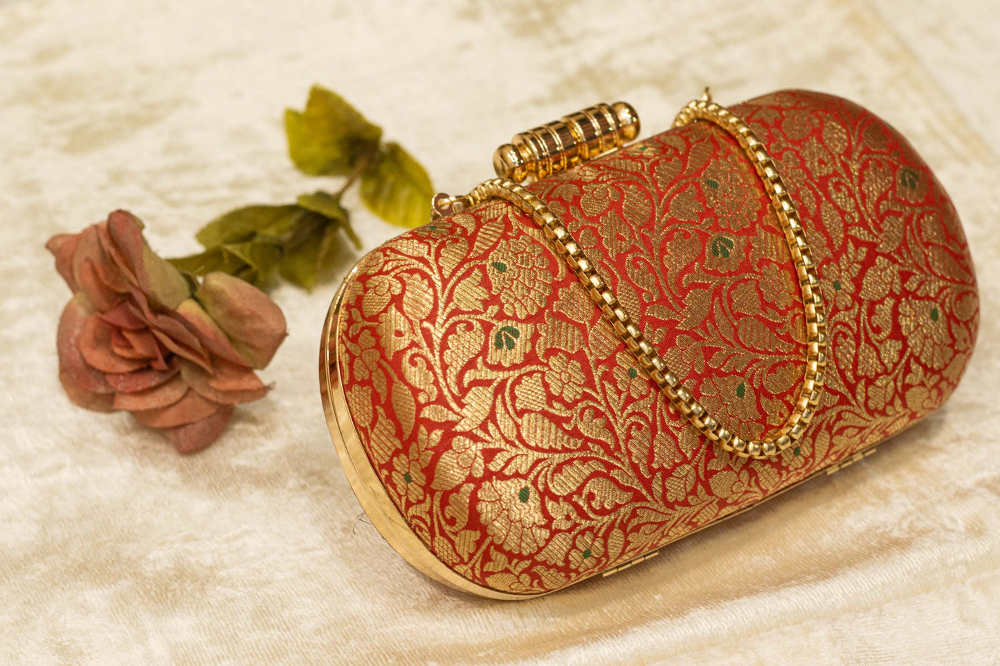 Red Banarasi brocade clutch bag with gold floral embroidery and ornate clasp, handmade traditional clutches.