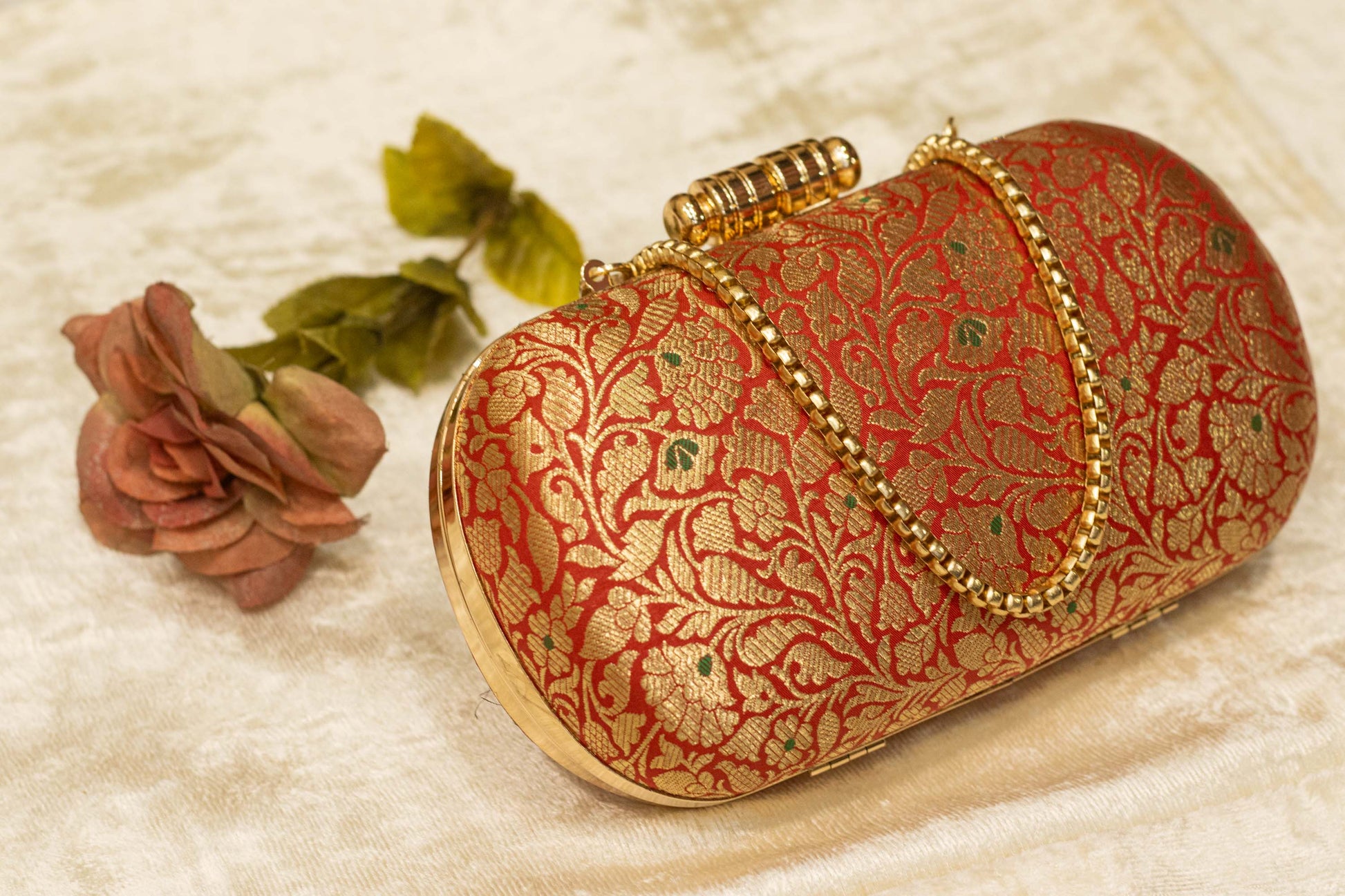 Red Banarasi brocade clutch bag with gold floral embroidery and ornate clasp, handmade traditional clutches.