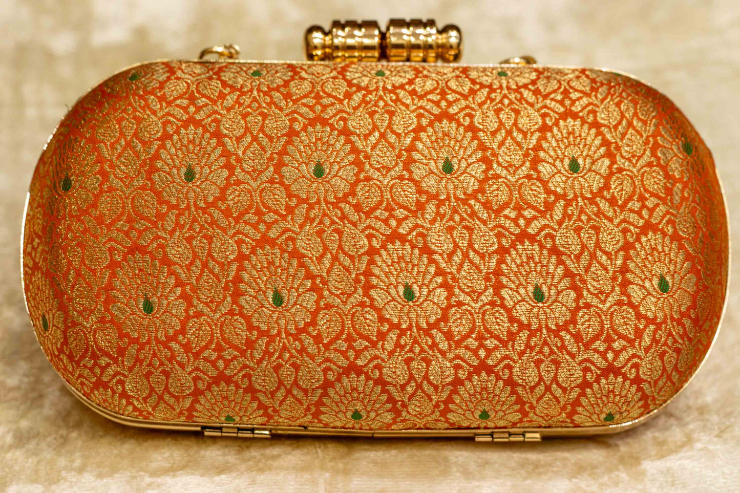 Saffron Banarasi brocade clutch bag with intricate traditional floral patterns, handmade capsule clutch style.