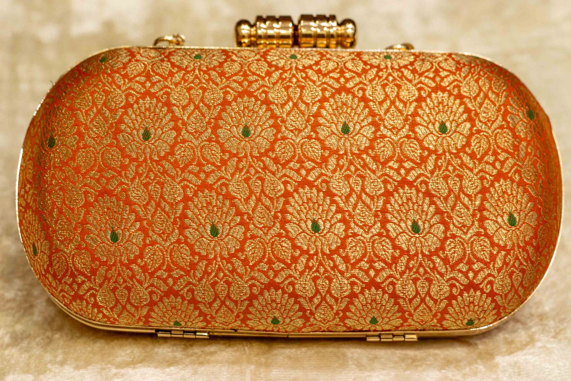 Saffron Banarasi brocade clutch bag with intricate traditional floral patterns, handmade capsule clutch style.