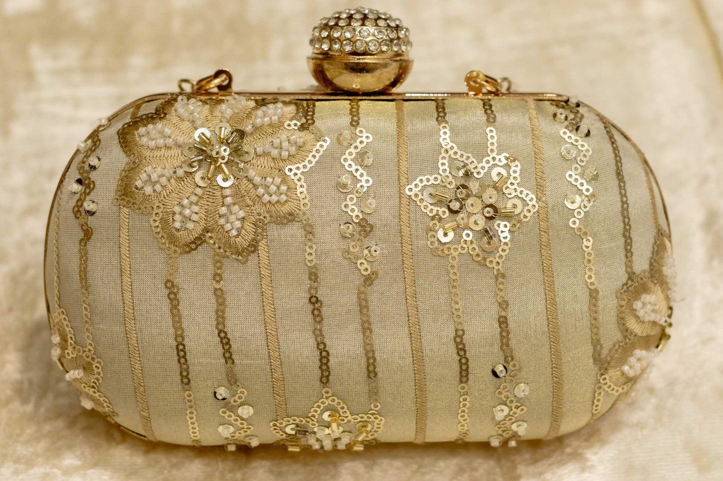 Sage green Banarasi brocade clutch bag with gold floral embroidery and jeweled clasp, handmade traditional clutches.