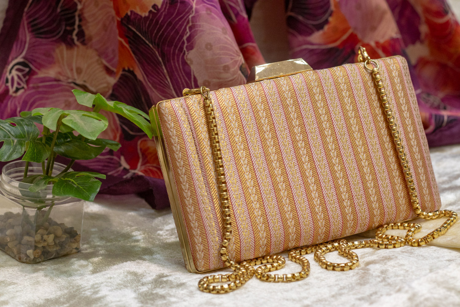 Baby pink Banarasi brocade clutch bag with gold chain, traditional handmade design.