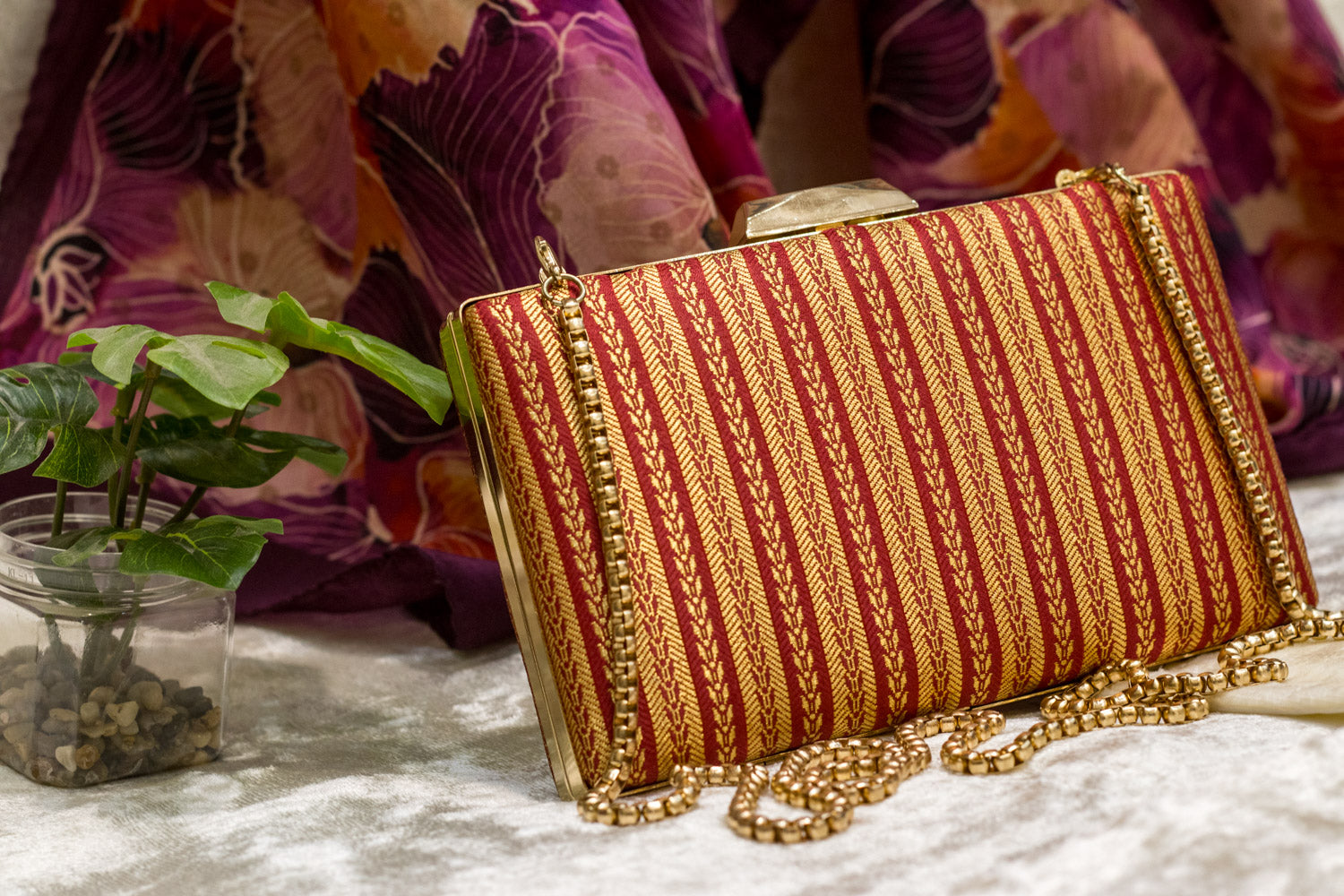 Red Banarasi brocade clutch bag with gold striped pattern, traditional handmade clutches with chain strap.