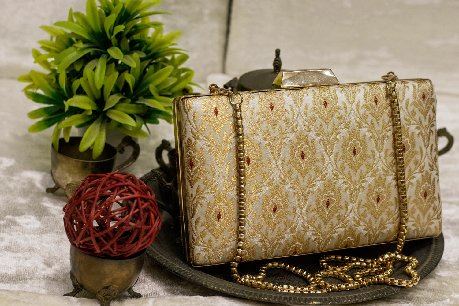 Ivory Banarasi brocade clutch bag with gold chain, traditional handmade design.