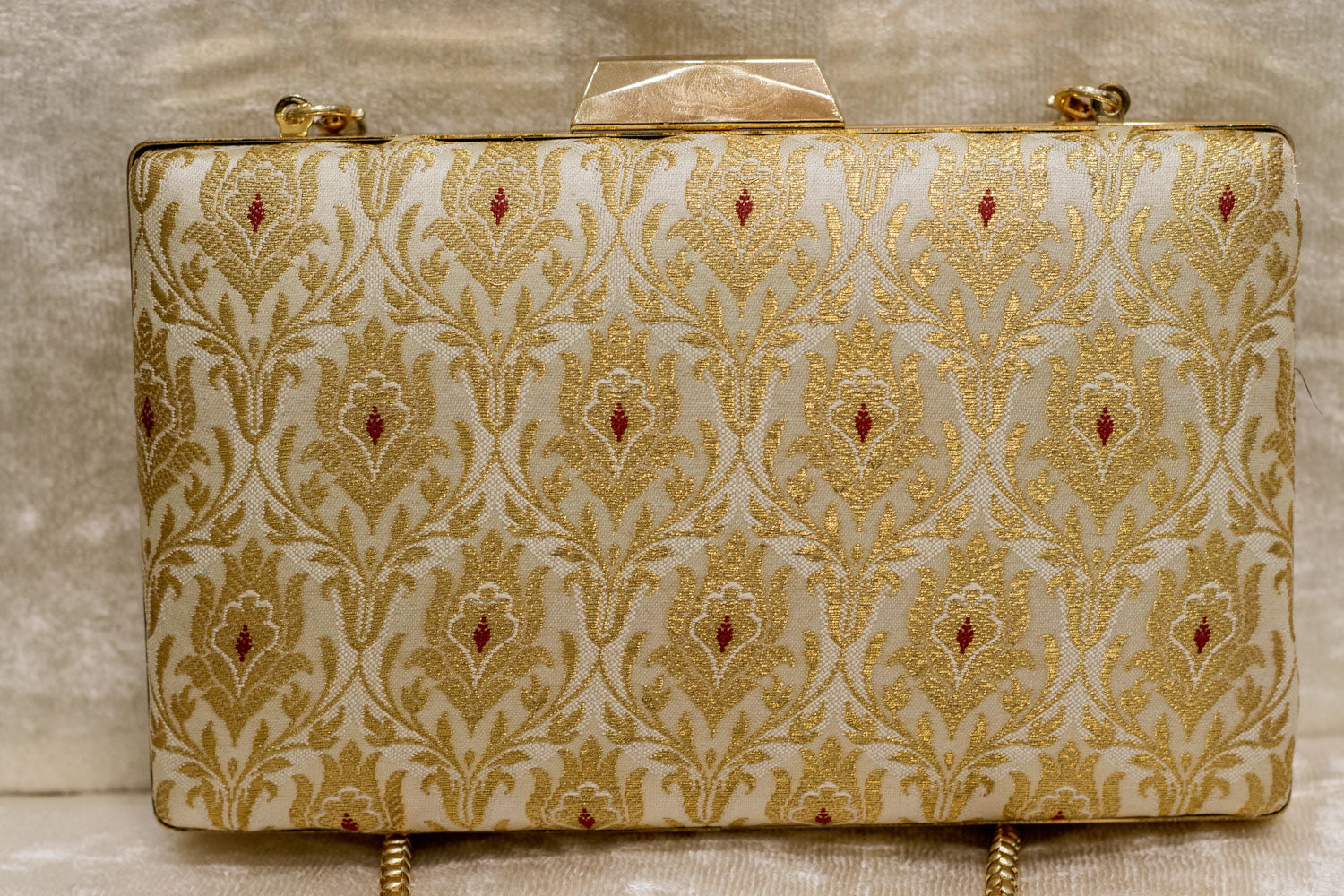 Ivory Banarasi brocade clutch bag with traditional gold floral patterns, handmade finish.