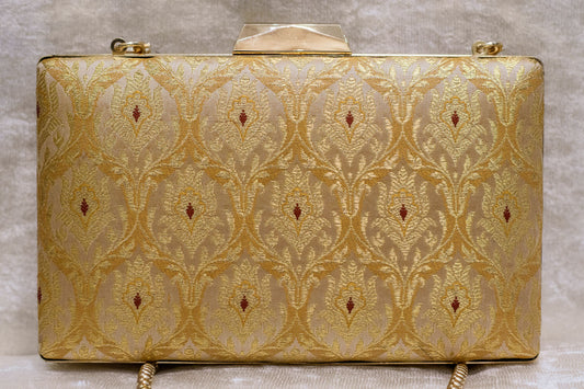 Golden Banarasi brocade clutch bag with traditional floral motifs and top handle, handmade design.