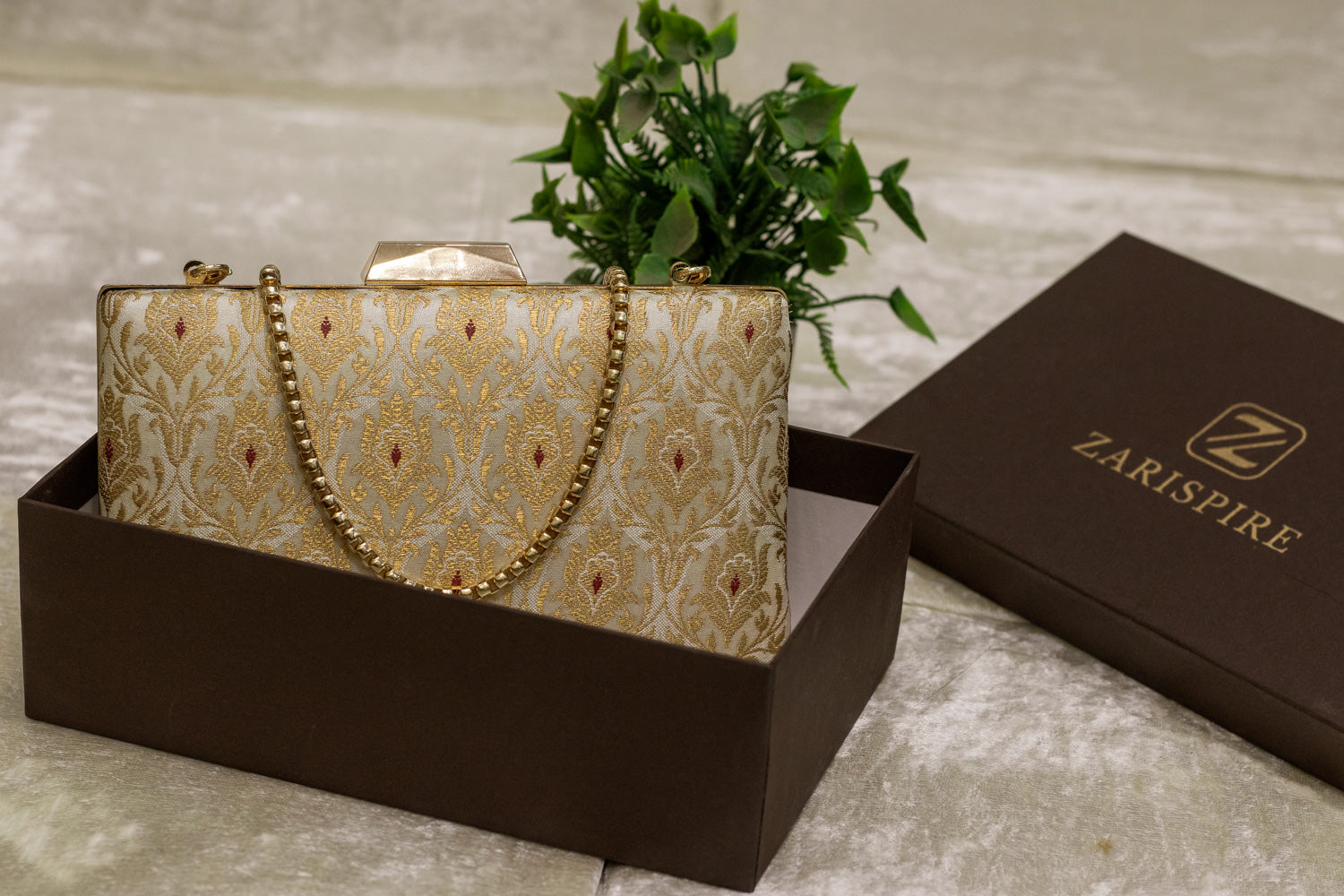 Ivory Banarasi brocade clutch bag with gold traditional pattern and chain strap, handmade design.