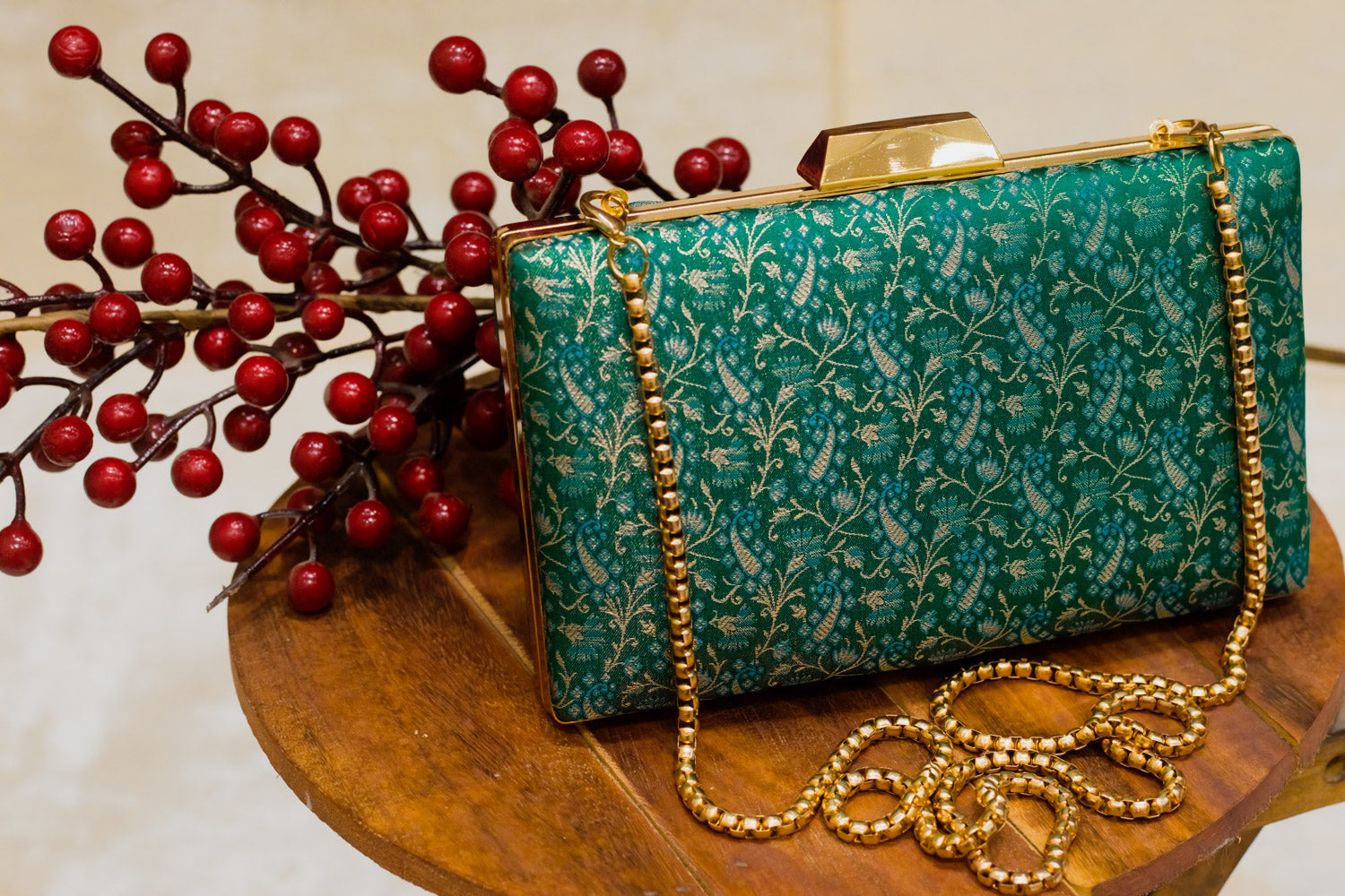 Teal Banarasi brocade clutch bag with gold chain and clasp, traditional handmade design.