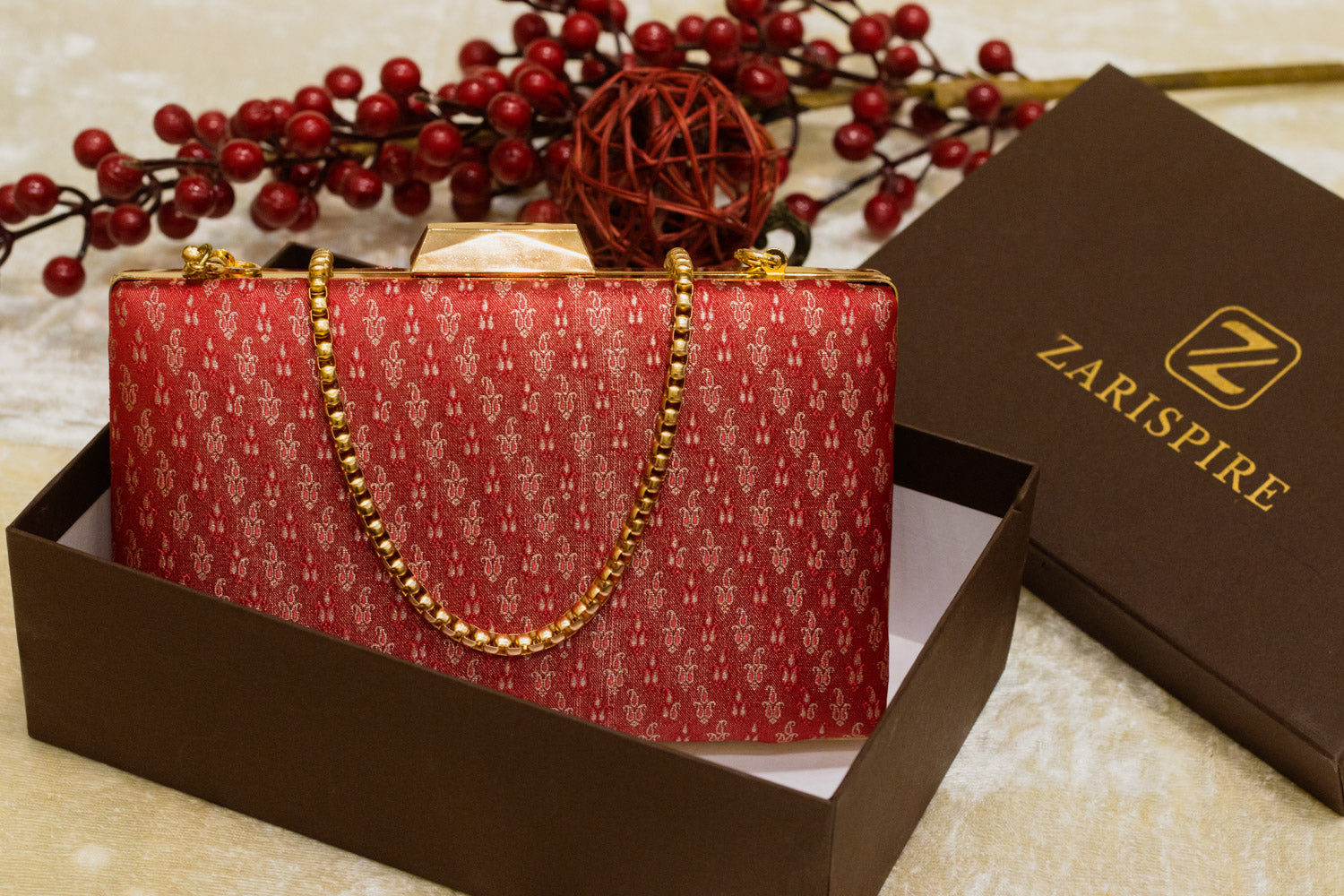 Red Banarasi brocade clutch bag with gold chain, traditional handmade design.