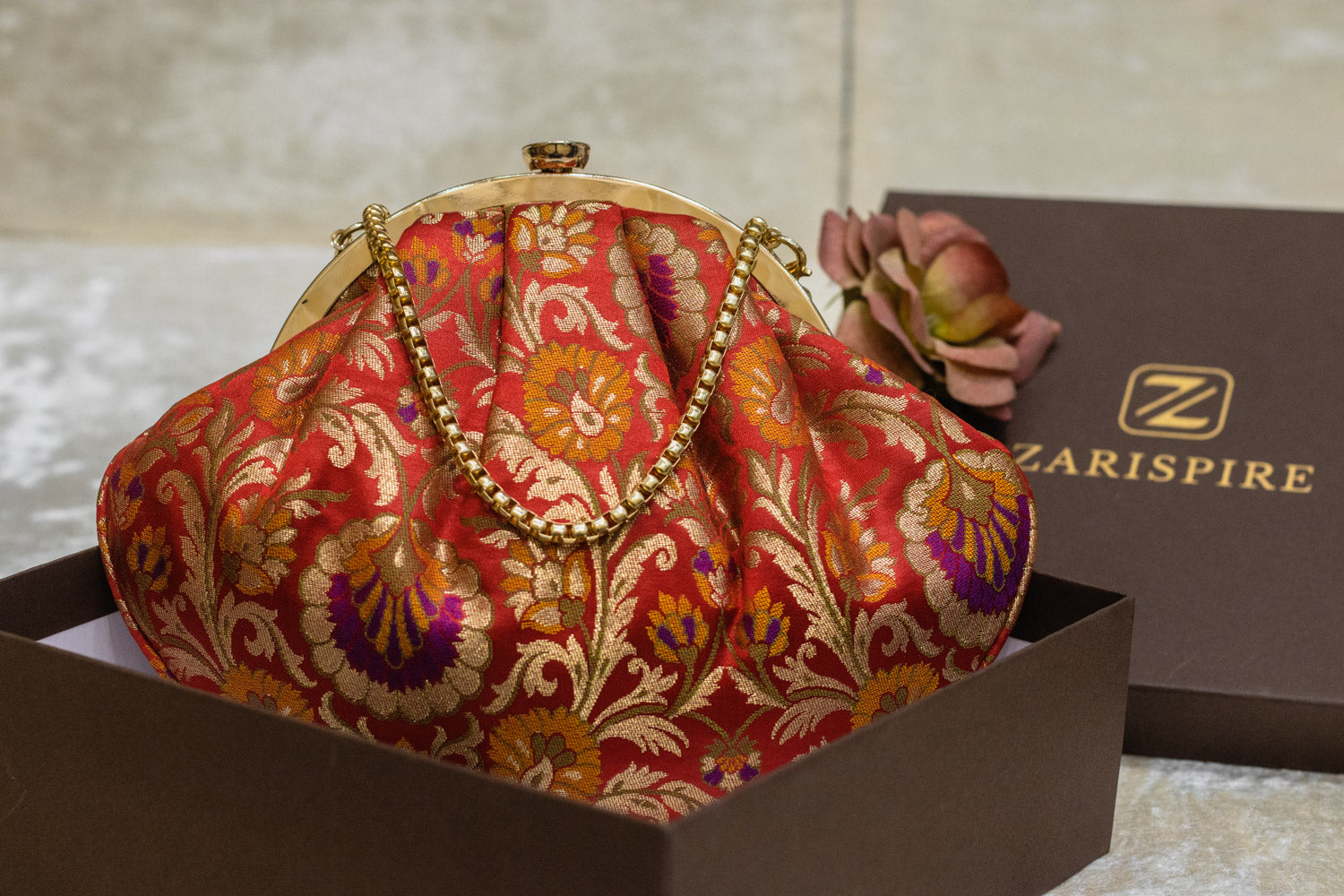 Red Banarasi brocade clutch bag with traditional floral pattern and gold chain strap, handmade.