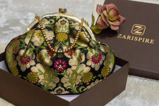 Black Banarasi brocade clutch bag with gold floral embroidery and traditional handmade design.