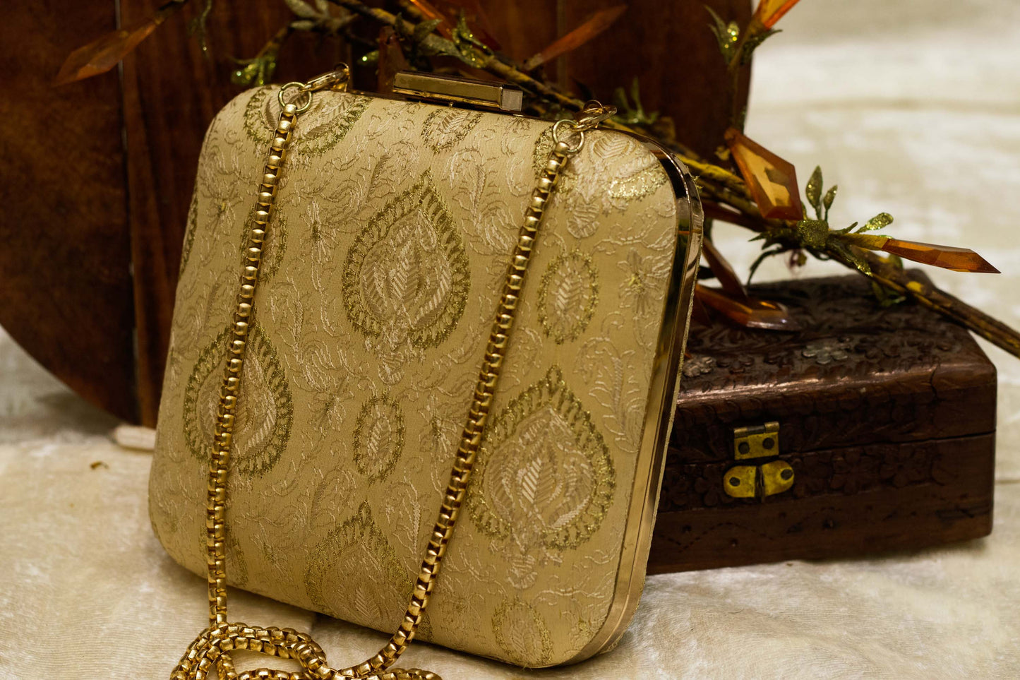 Traditional handmade Banarasi brocade clutch bag in beige with gold embroidery and chain strap.