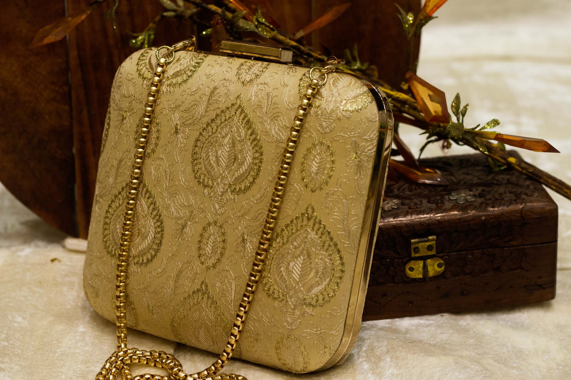 Traditional handmade Banarasi brocade clutch bag in beige with gold embroidery and chain strap.