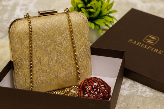 Beige Banarasi brocade clutch bag with gold chain, traditional handmade design in gift box.